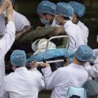 A coal miner rescued from the Wangjialing Coal Mine in Xiangning county is rushed into a hospital...