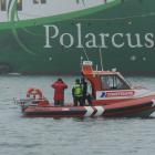A coastguard launch stands by; police vehicles positioned at Back Beach, Port Chalmers. Photos by...