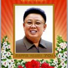 A commemorative stamp featuring late North Korean leader Kim Jong-il. The Korean characters read ...