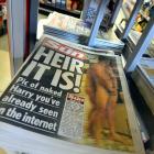 A copy of The Sun newspaper featuring a picture of a naked Prince Harry is seen in a shop in...