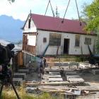 A crane hoists the historic New Zealand Railways ticket office off its piles   last week, for ...