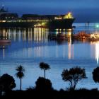 A crayfish boat prepares to head out of Careys Bay about 6am last Thursday as the container ship...