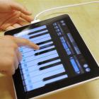 A customer plays a piano in the new iPad tablet computer at an Apple store in Barcelona, Spain.(...