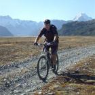 A cyclist heads away from Mount Cook at the start of what will become the Alps 2 Ocean cycle...