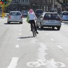 A cyclist wobbles as three vehicles in close succession cross the cycle lane in front of her near...