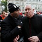 A demonstrator directs questions to the Dean of St Paul's, the Right Reverend Graeme Knowles,...