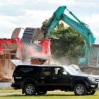A digger demolishes buildings at the former Waldronville School to make way for a new residential...