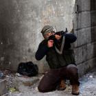 A fighter from the Sadik unit of Free Syrian Army's Tahrir al Sham brigade aims his rifle in...