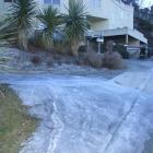 A frozen flow of water emerges from a burst pipe on Richards Park Lane, in Fernhill, Queenstown....