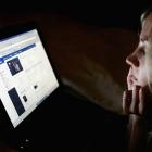 A girl in London looks at a page on Facebook. Studies have shown that many teens using social...