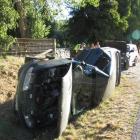 A green Holden Berlina landed on its side after a collision with another car caused it to slide...