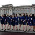 A group of students from the Royal College of Art pose for photographs wearing Kate Middleton...