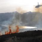 A helicopter attacks an out-of-control burn-off, covering an estimated 40ha, near the Remarkables...