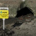 A hole in the kerb is made to look like a cave, complete with information sign for visitors....