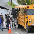 A Hollywood film crew shoots a scene from Pete's Dragon on a yellow school bus in Tapanui...