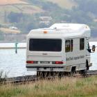 A KiwiRail inspection vehicle travels down the railway line between Port Chalmers and Dunedin.