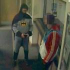 A man dressed as Batman and a burglary suspect stand in a police station in Bradford, northern...