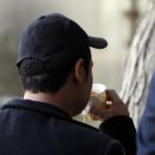 A man who goes by the name Haifa drinks tea with his back to the camera so as not to be...