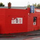 A man wielding a hammer demanded money from the owner of the Pine Hill Dairy in Dunedin on Sunday...