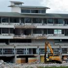 A mechanical excavator stands beneath  Carisbrook's terrace hospitality complex as demolition of...