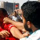 A member of the Muslim Brotherhood punches an anti-Brotherhood protester at Tahrir Square, the...