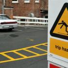 A new trip hazard warning sign and repaired pothole in Dowling St car park yesterday. Photo by...
