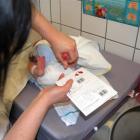 A newborn has a neonatal heel prick.