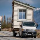 A piece  of the former Glenorchy school house is transported to a new site at Paradise, 20km away...