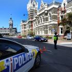 A police officer diverts traffic away from the Dunedin court house yesterday. Photos by Staff...