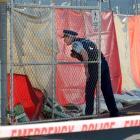 A police officer keeps guard at  a property in Strathallan St, Dunedin, after a body was...