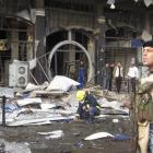 A police officer provides security at the site of a bomb attack overnight in Baghdad's...