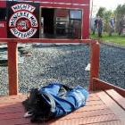 A police vest remains on the deck at the back of a house, as police work to remove a section of...