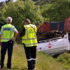 A policeman and  KiwiRail worker  on the  scene across from the Mill House, Waianakarua, on...