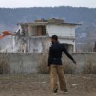 A policeman looks on as the building where al Qaeda leader Osama bin Laden was killed is...