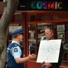A policeman talks to Calvin Hooper about his protest in Dunedin yesterday against synthetic...