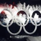 A snowboarder flies through the Olympic rings at the opening ceremony of the Vancouver Winter...