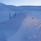 A snowbound car waits for the thaw near the summit of the range. Photos by Marjorie Cook.