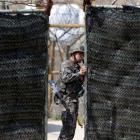A South Korean soldier opens a gate at a checkpoint near the demilitarized zone separating North...