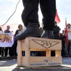 A speaker addresses the crowd of about 200 people attending a protest held at the Dunedin Railway...