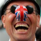 A spectator dressed as a policeman laughs outside Westminster Abbey on the eve of the Royal...