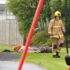 A St Kilda firefighter walks from the scene of a deliberately fire at a Dunedin playground...