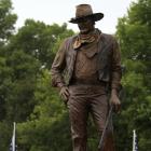 A statue of John Wayne, donated by his children, stands on the site in Winterset, Iowa, where a...