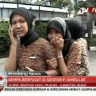 A still image taken from video shows a woman speaking on her mobile phone after an earthquake in...