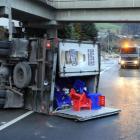 A truck arrives to spread grit at the southern end of Kaikorai Valley Rd yesterday morning, but...