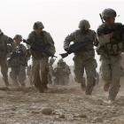 A US soldier returns fire as others run for cover during a firefight with insurgents in the...