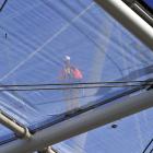 A workman can been through one of the first sections of ETFE that make up the Forsyth Barr...