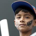 A young supporter of New Zealand's World Cup Cricket team waits for the start of play against...