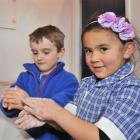 Abbotsford School pupils Harry Bond (left) and Layla Barton  (both 5) wash their hands in a bid...