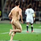 Adam Holtslag runs naked before being tackled by a security guard at the All Blacks v England...