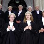 Admitted to the bar yesterday, moved by their fathers are (front, from left) Tommy Rutherford (24...